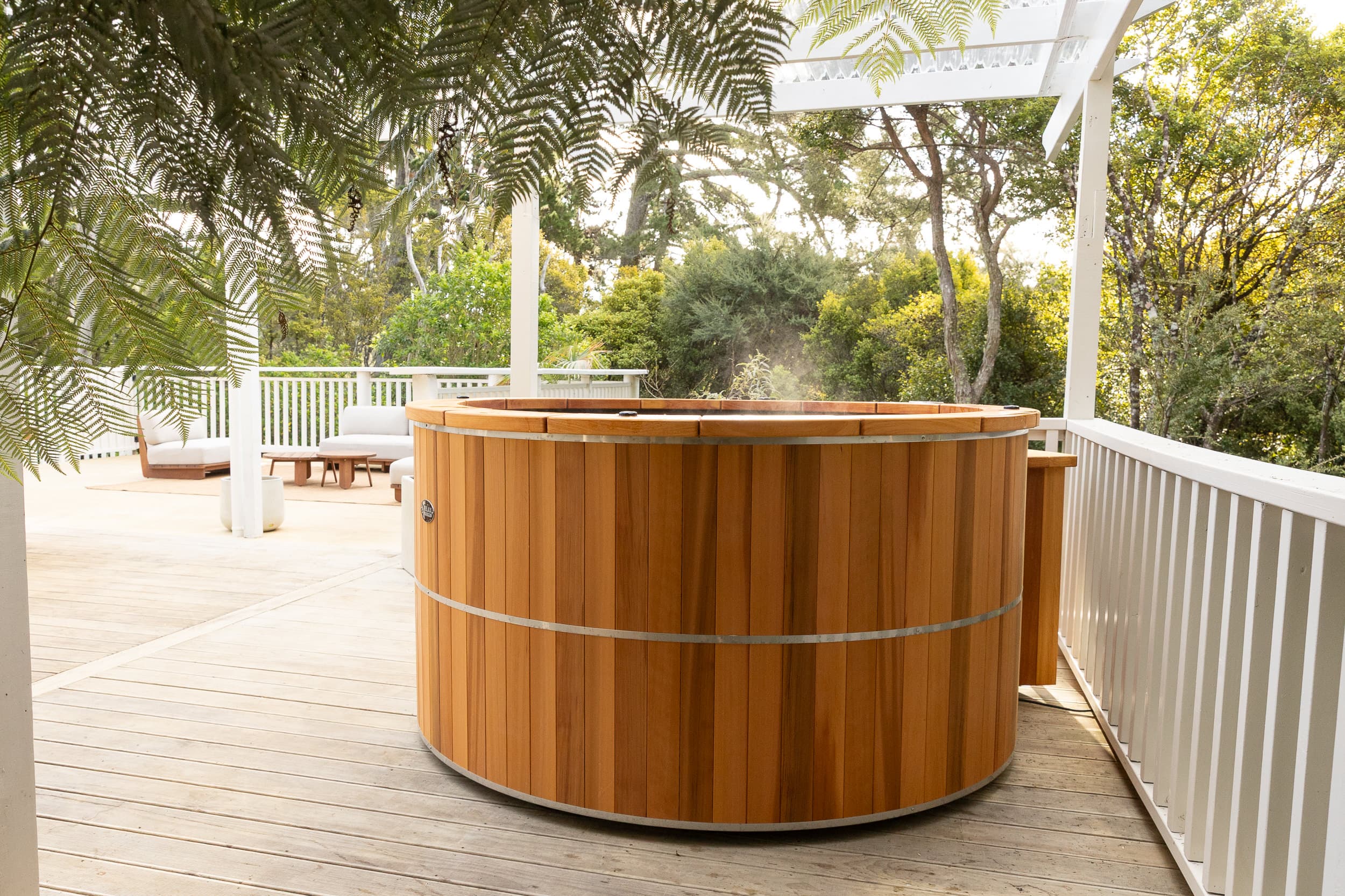 Heated spa pool on a private bush-fringed deck
